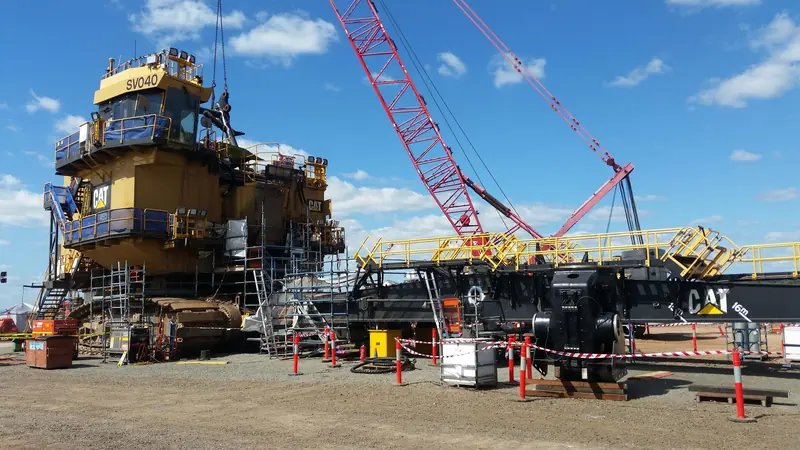 Electric rope shovel boom on stands beside the shovel during an outage
